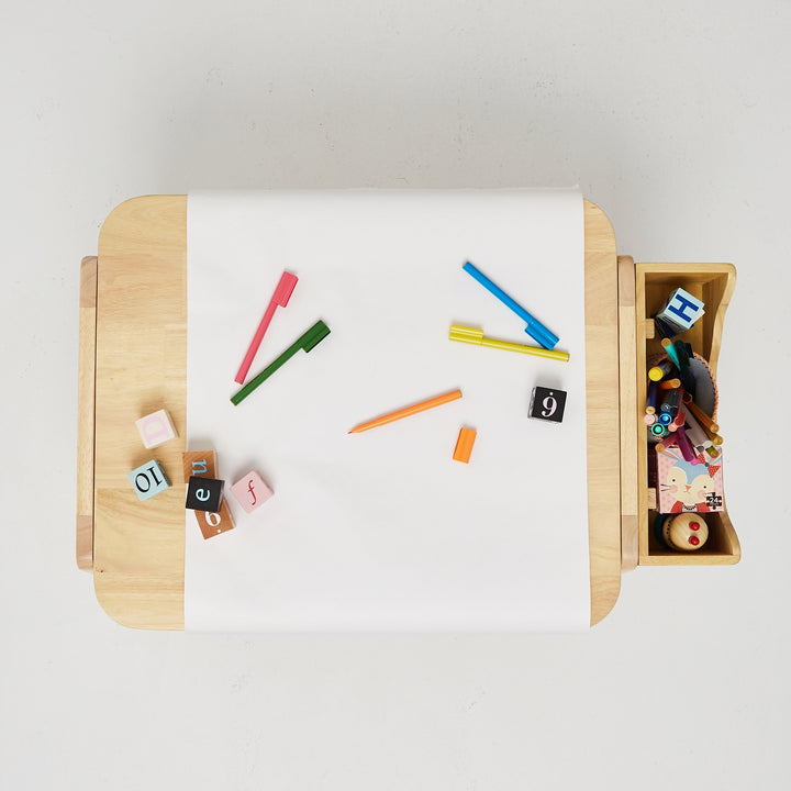 a wooden tray with a roll of white paper on top of it