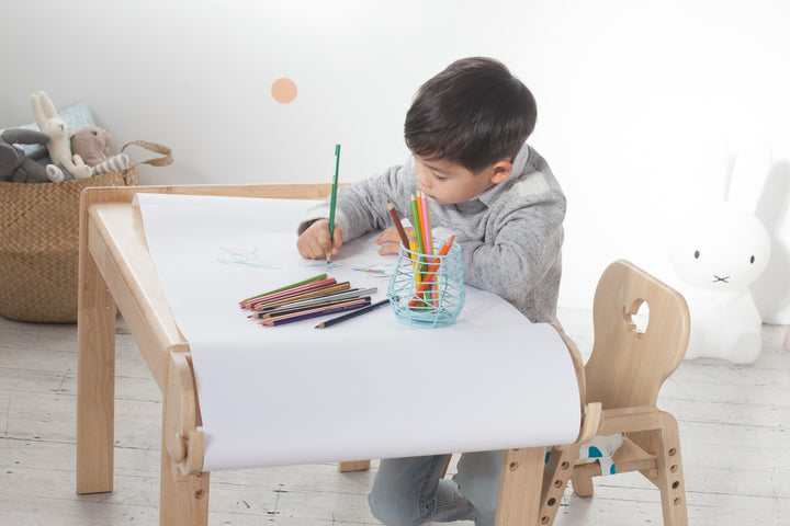 a little boy that is sitting at a table