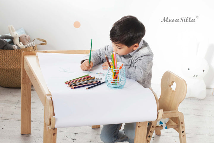 a little boy that is sitting at a table