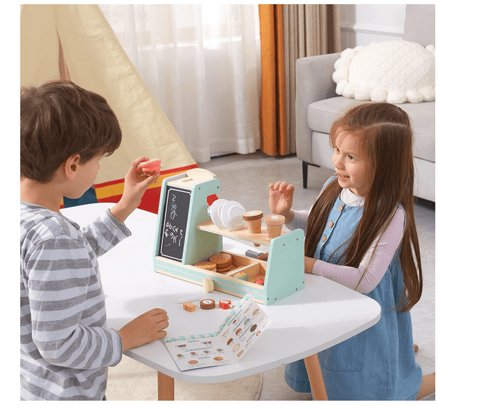 two children playing with a toy kitchen set