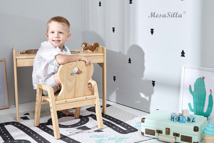 a little boy that is sitting in a chair