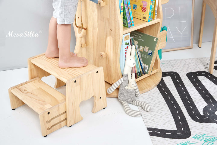 a child standing on a wooden step stool next to a bookshelf