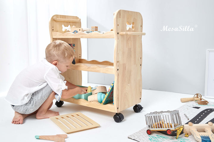 a toddler playing with a wooden toy truck