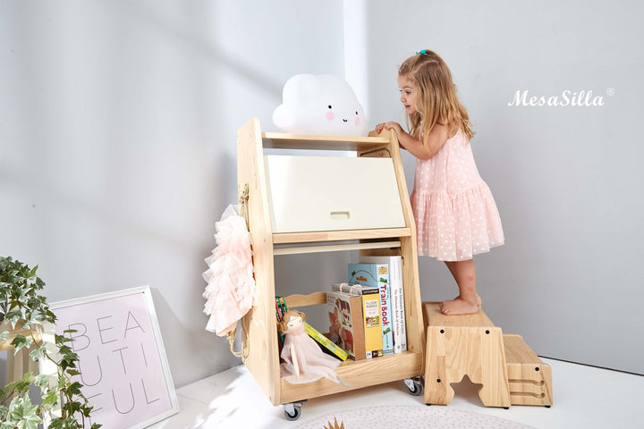 a little girl standing on top of a wooden book shelf