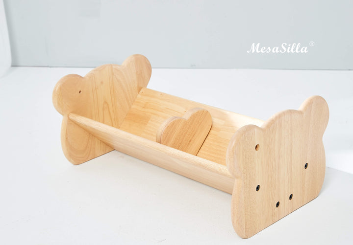 a wooden toy bear sleigh on a white surface