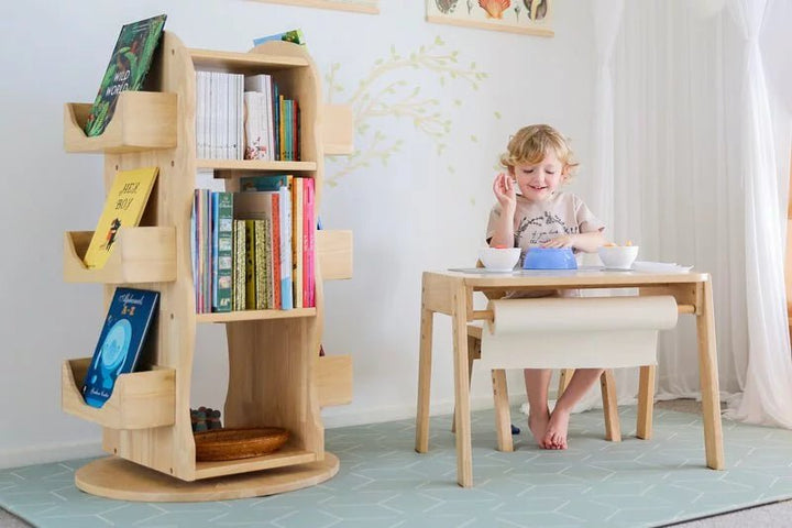 a little girl that is sitting at a table