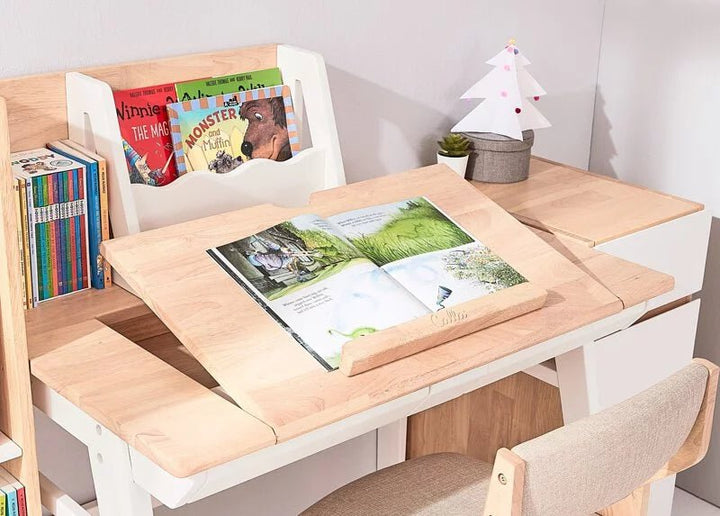 a children's desk with books and a toy tree