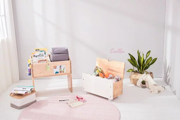 a white room with a pink rug and wooden furniture