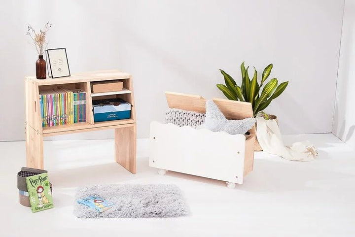 a white room with a book shelf and a white couch