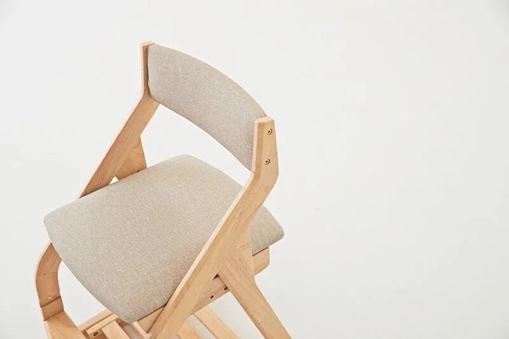 a wooden rocking chair with a beige seat